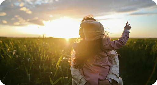 Child in a golden field at sunset