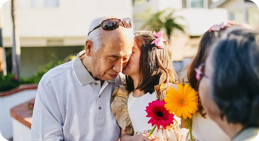Grandparents with granddaughter and flowers